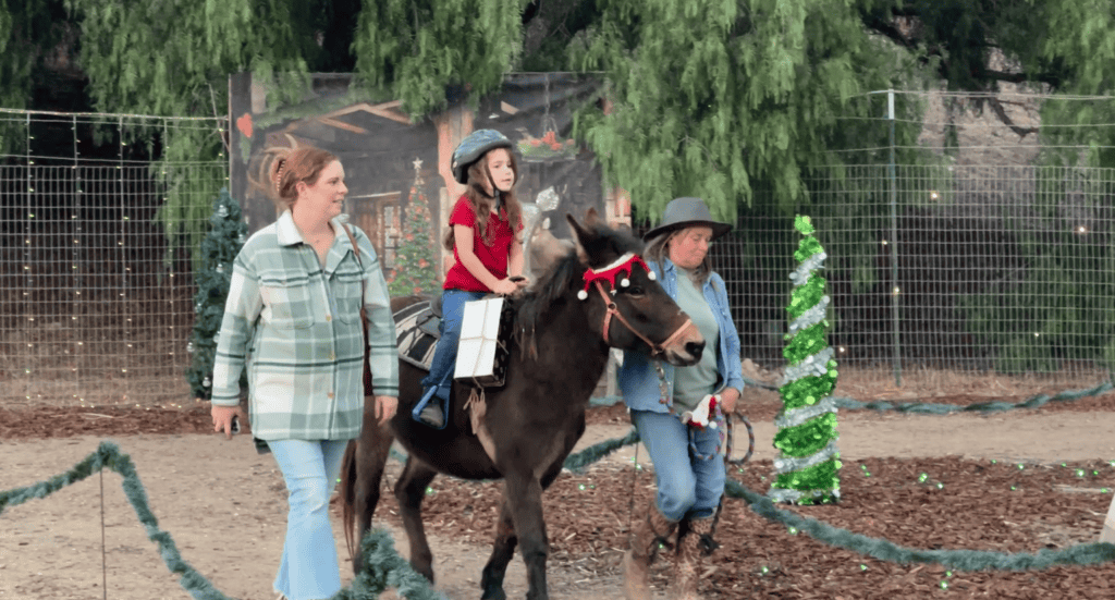 Young child riding a pony at A Cowboy Christmas in Buellton, CA